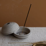 Ceramic incense holder with an incense stick for meditation and mindfulness rituals 